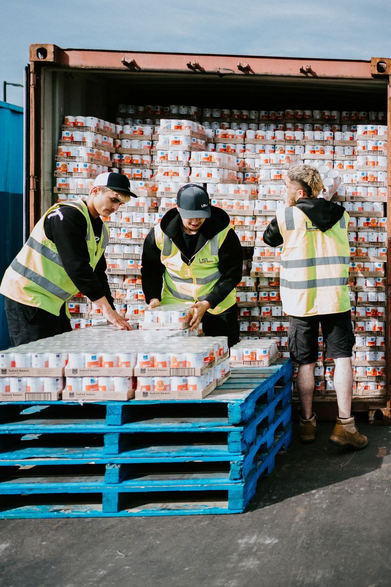 An LSL crew stacking cartons onto pallets at the container door